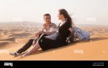 loving-young-couple-meet-sunrise-in-the-arabian-desert-after-date-2BHGE0B.jpg